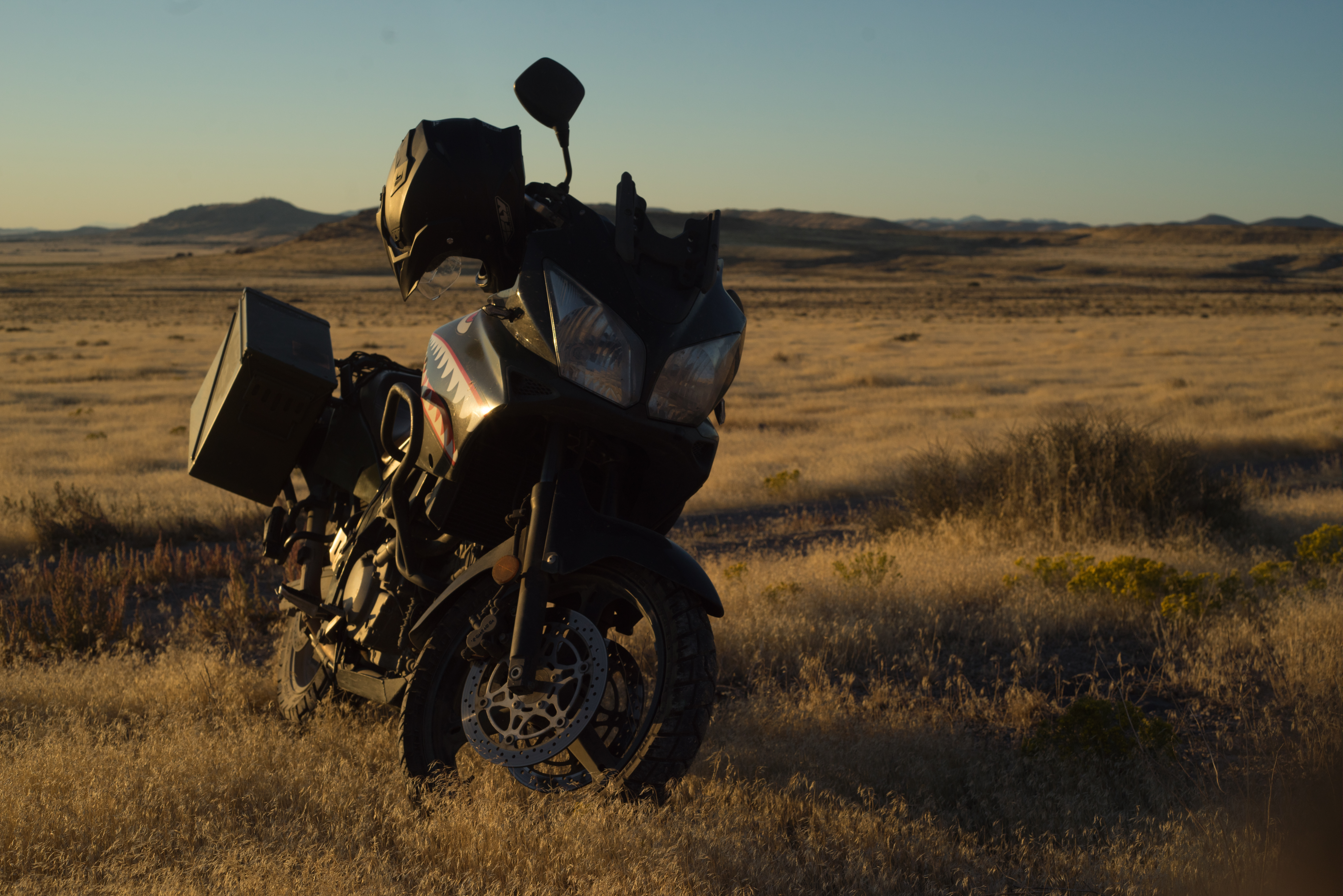 Motorcycle above a golden grass prairie. 