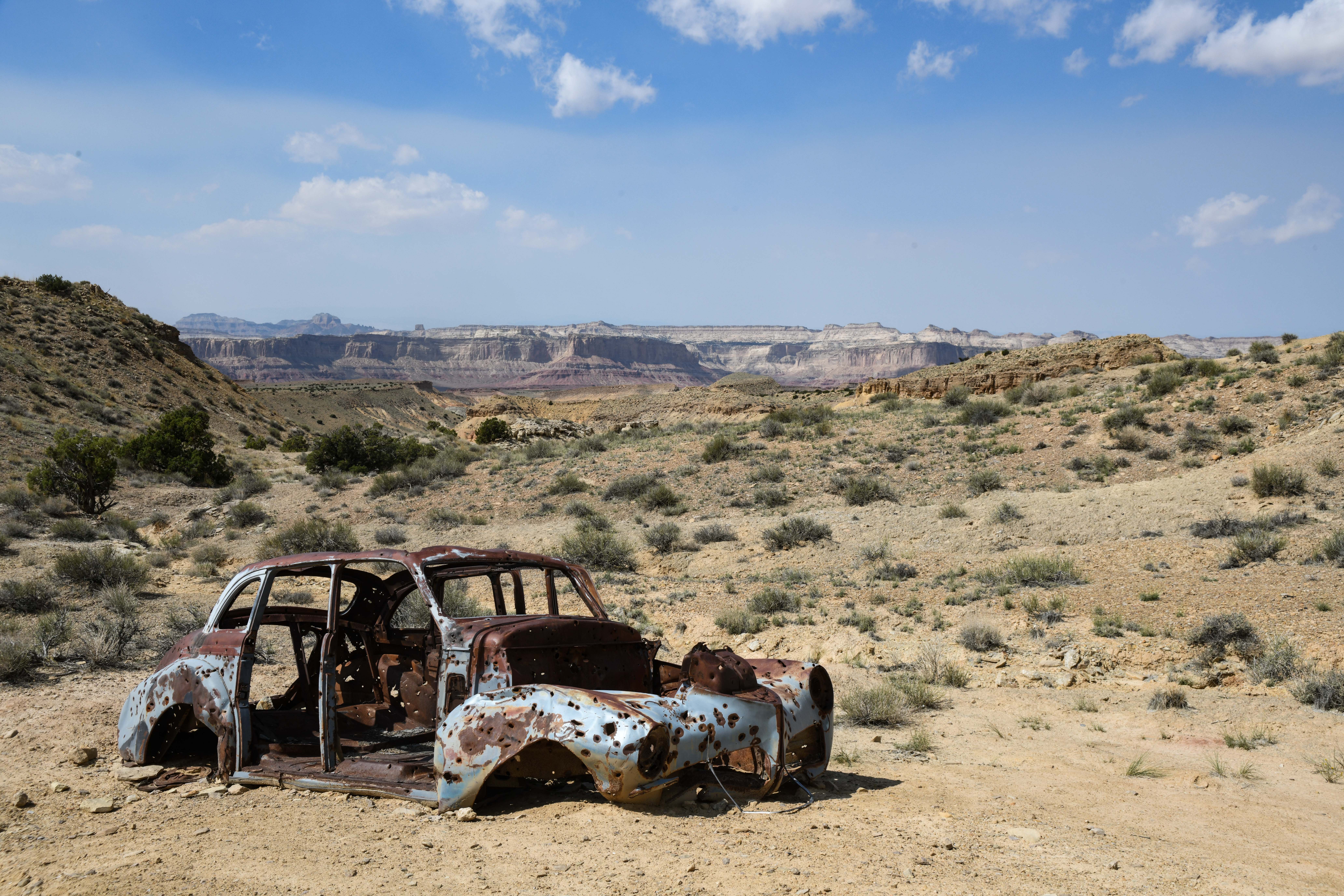 Abandoned car deteriorating in the desert.